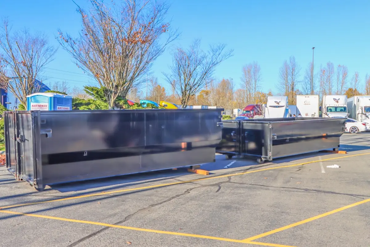 Professional dumpster rental service with roll-off container on residential driveway in Glenpool